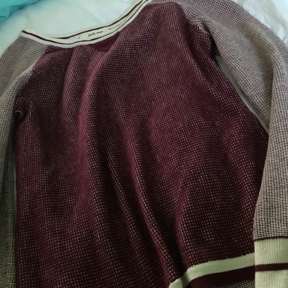 A red/white long sleeve sweater